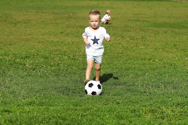 Deux mignons petits garçons jouant au football