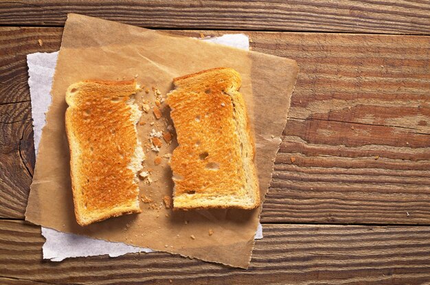 Deux pains à moitié grillés sur la vieille vue de dessus de table en bois Espace pour le texte