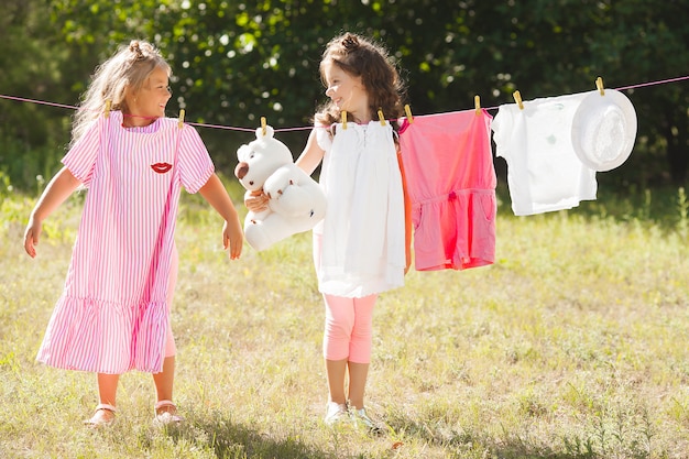 Deux petites filles en train de laver. Soeurs, faire ménage