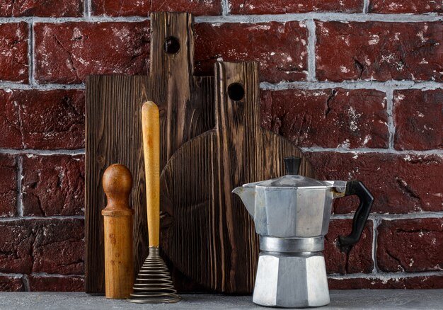 Deux planches à découper en bois et des ustensiles de cuisine. Pot de moka