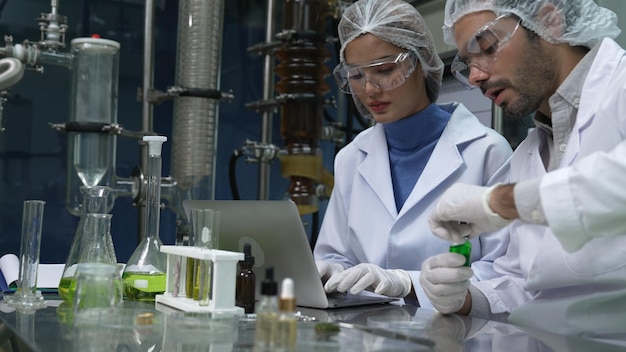 Deux scientifiques en uniforme professionnel travaillant en laboratoire