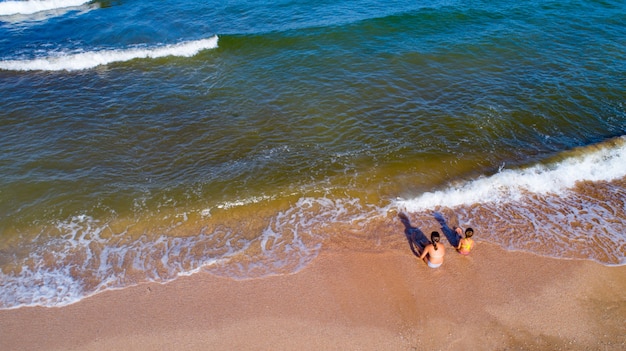 Deux sœurs jouant avec du sable sur la côte de la mer