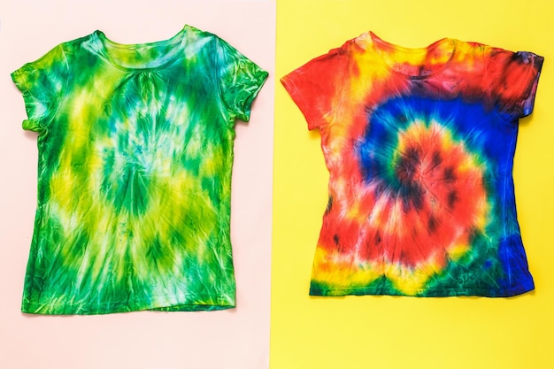 Deux t-shirts tie-dye peints à la main sur un fond bicolore Mise à plat