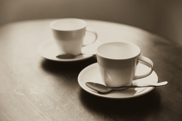 Deux tasse de café sur la table en bois rencontre ton concept de couleur vintage