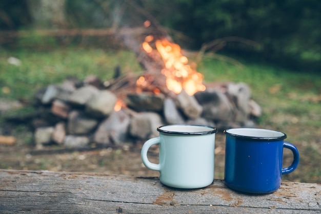 Deux tasses en métal avec feu de thé sur fond