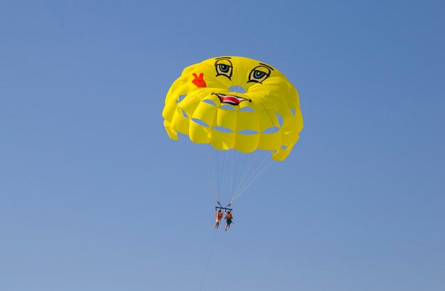 deux touristes faisant du parachute ascensionnel au-dessus de la mer