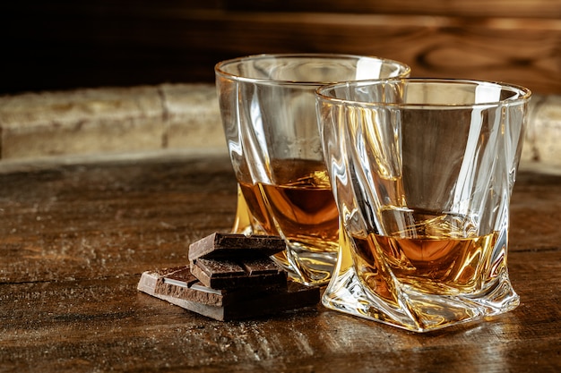 Deux verres de bourbon ou de scotch, ou de cognac et des morceaux de chocolat noir