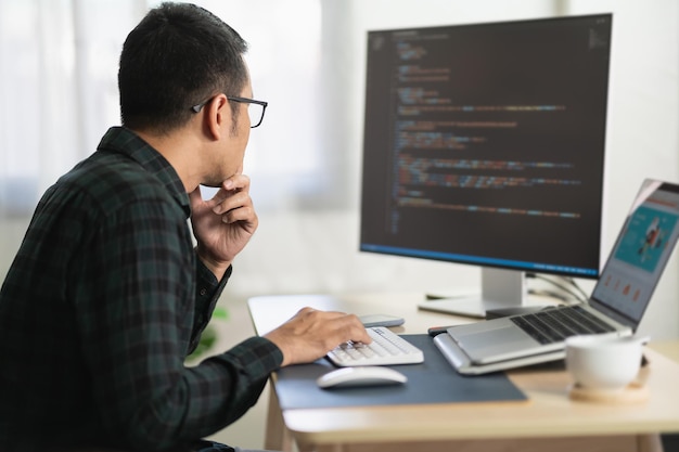 Développeur de logiciels travaillant sur ordinateur portable au bureau à domicile. Programmeur travaillant à développer une application Web. Concept de programmation logicielle