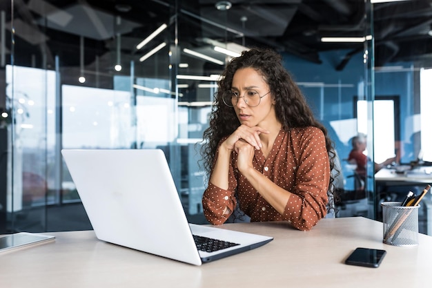 Développeur web programmeur féminin pensif et concentré travaillant dans une société de développement de produits moderne