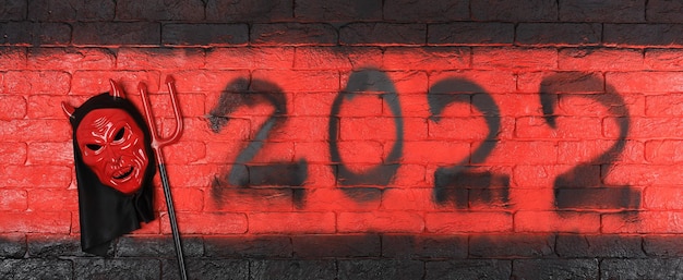 diable noir numéros 2022 sur un mur de briques rouges