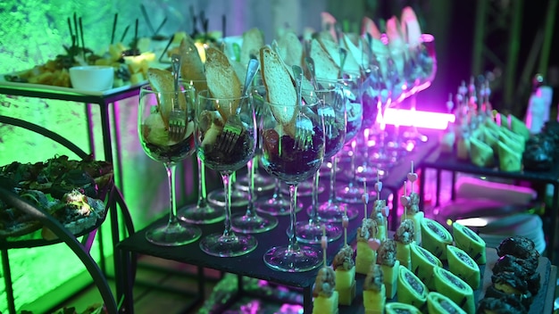 Différents types de collations et de boissons pour une table de buffet de fête amusante au néon vert