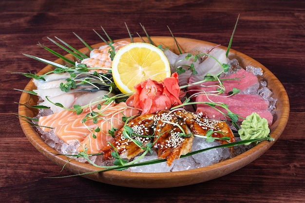 Différents types de poissons sur une assiette avec de la glace et du citron