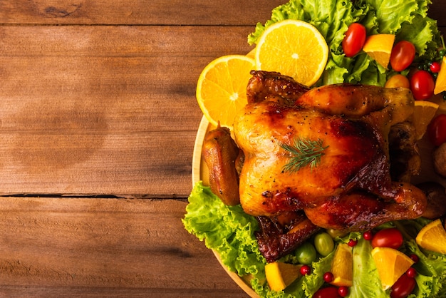 Dinde rôtie de Thanksgiving ou poulet et légumes sur table en bois