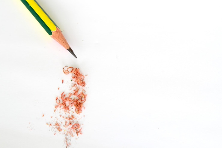 Photo directement au-dessus d'un coup de crayon et de copeaux sur fond blanc