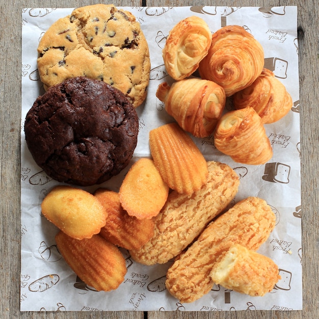 Divers Gâteaux De Pâtisserie Française Sur Table En Bois Rustique Madeleine Craquelin Eclair Mini Croissant