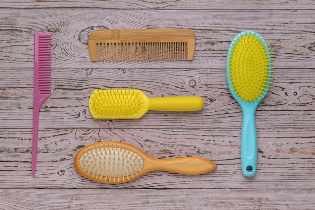 Divers peignes à cheveux sur un fond en bois Accessoires pour le soin des cheveux