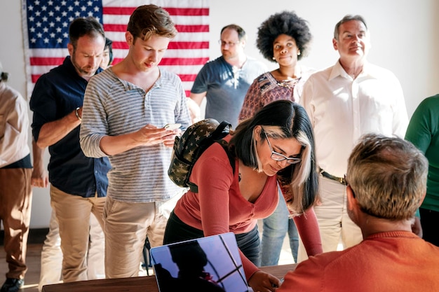 Diverse personnes en file d'attente à un bureau de vote