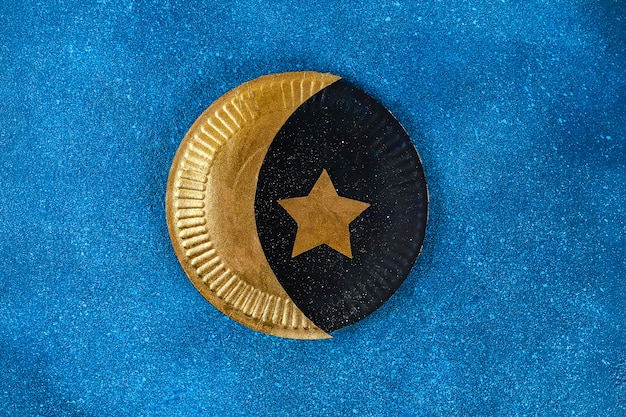 Diy Ramadan Kareem croissant de lune avec une étoile d&#39;une plaque de carton jetable et peinture dorée.