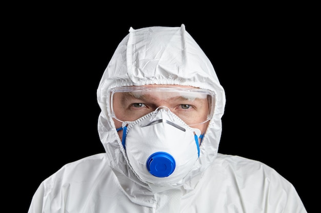 Docteur en tenue de protection blanche et respirateur et lunettes