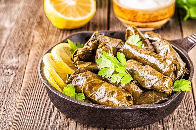 Dolma, feuilles de vigne farcies avec du riz et de la viande sur fond sombre, mise au point sélective.