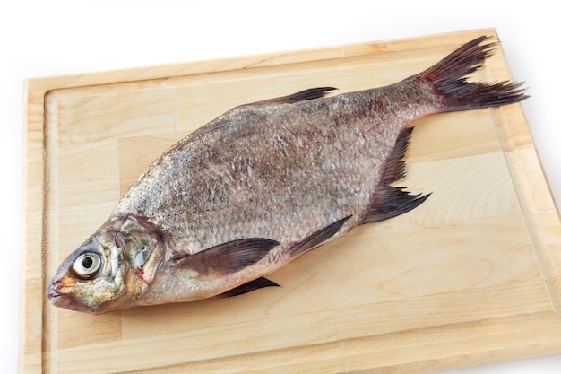 Dorade commune sur planche à découper isolé sur fond blanc Poisson d'eau douce