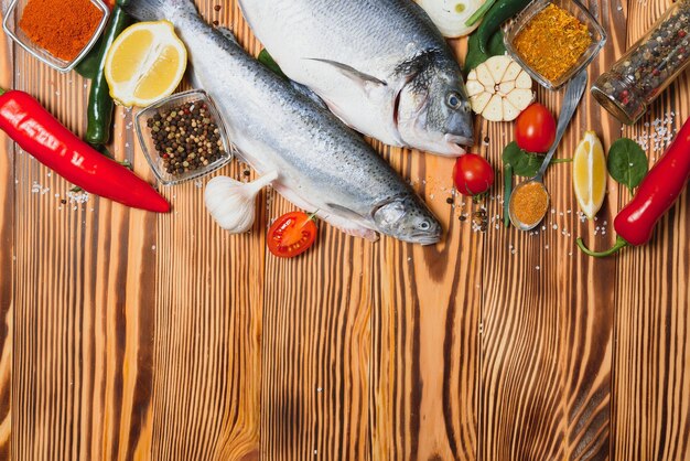 Dorado cru et poisson truite aux épices cuisson sur planche à découper.