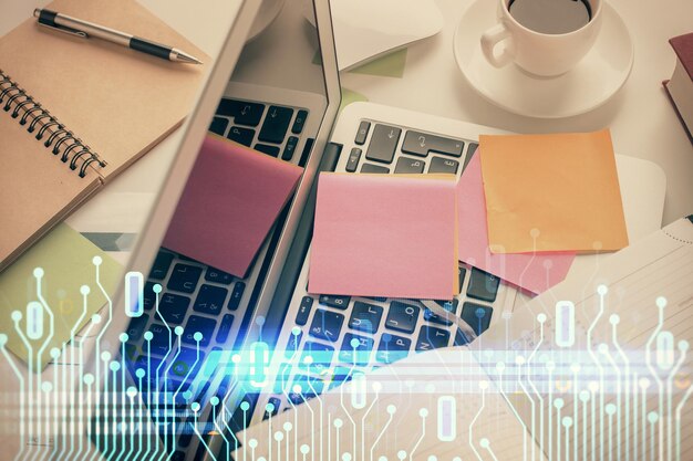 Double exposition d'un croquis d'hologramme de données sur fond de table d'étude avec concept informatique de la vue de dessus Ai