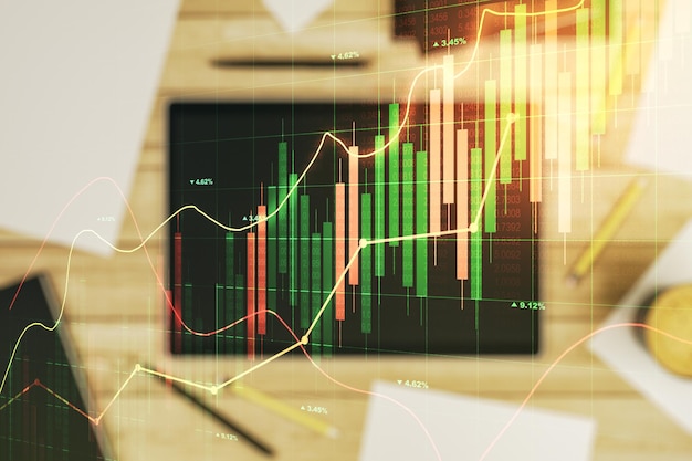 Double exposition d'un diagramme financier créatif abstrait et d'une tablette numérique moderne sur le concept bancaire et comptable d'arrière-plan