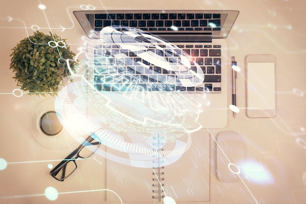 Double exposition de l'hologramme de dessin de données sur la vue de dessus de l'arrière-plan du bureau d'étude avec le concept informatique de l'IA