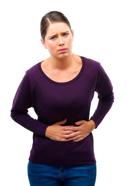 Douleur d'estomac et portrait de femme en studio avec les mains période et digestion par fond blanc Personne de fille et modèle avec constipation gaz ou abdomen avec diarrhée épuisement ou inquiétude avec la maladie