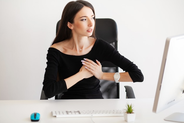 Douleur thoracique. Femme ayant une attaque de panique au travail