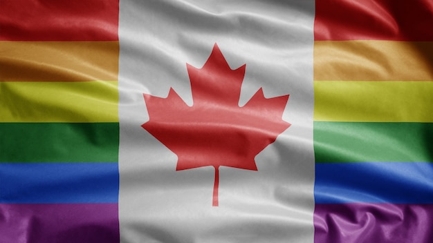 Drapeau canadien de la fierté gaie flottant dans le vent. Gros plan de la bannière de la communauté LGBT du Canada soufflant de la soie lisse. Fond d'enseigne de texture tissu tissu