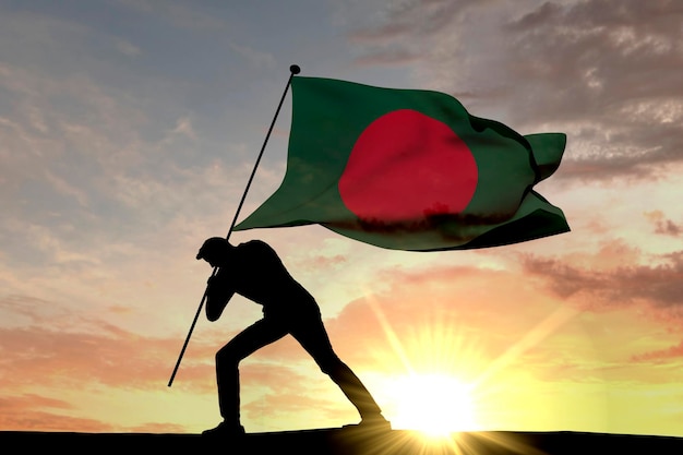 Drapeau du Bangladesh poussé dans le sol par une silhouette masculine rendu 3D