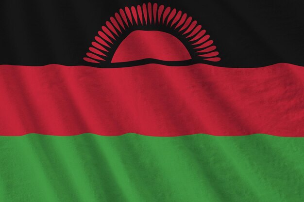 Drapeau du Malawi avec de grands plis agitant de près sous la lumière du studio à l'intérieur Les symboles officiels et les couleurs de la bannière