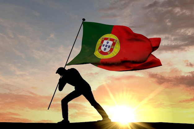 Drapeau du Portugal poussé dans le sol par une silhouette masculine rendu 3D