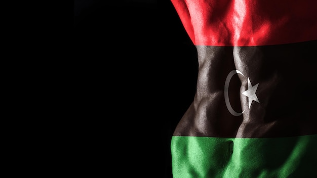 Drapeau de la Libye sur l'entraînement sportif national des muscles abdominaux, concept de musculation, fond noir