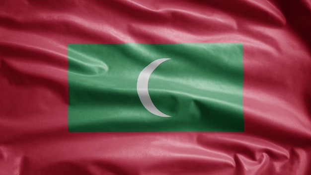 Drapeau maldivien agitant dans le vent. Bannière des Maldives soufflant de la soie douce. Fond d'enseigne de texture tissu tissu