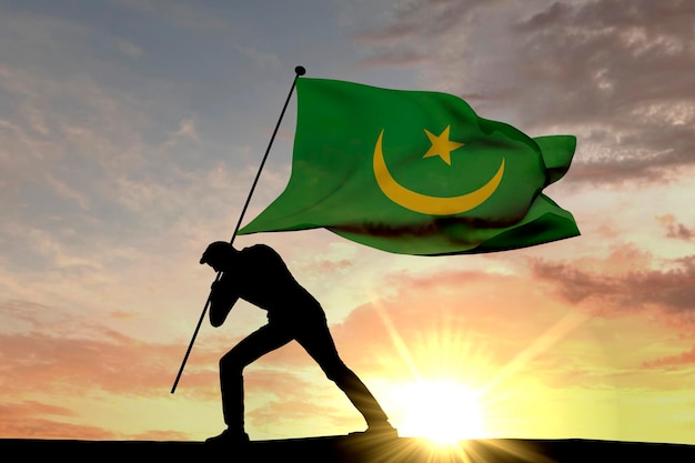 Drapeau mauritanien poussé dans le sol par une silhouette masculine rendu 3D