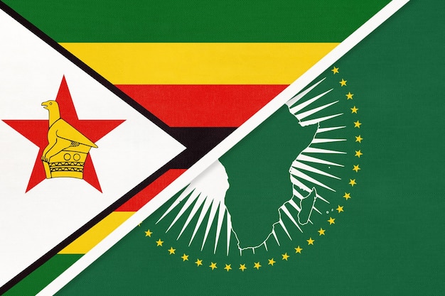 Photo drapeau national de l'union africaine et du zimbabwe du continent africain textile contre le symbole zimbabwéen