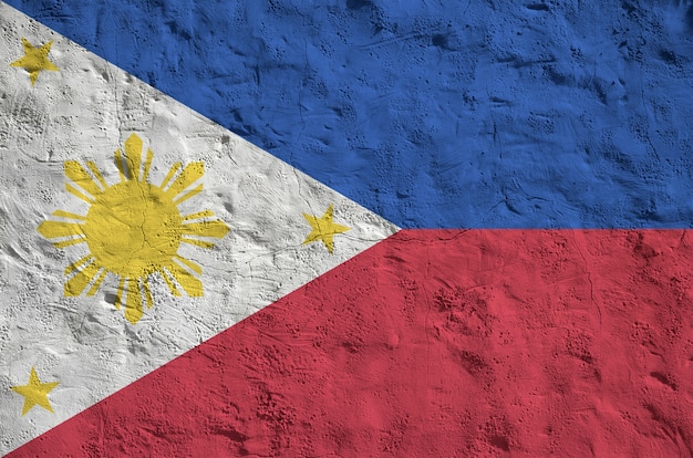 Drapeau des Philippines représenté dans des couleurs vives sur fond de plâtrage en relief