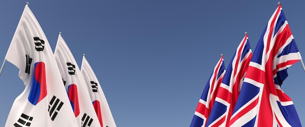 Drapeaux du Royaume-Uni et de la Corée du Sud sur des mâts sur les côtés Six drapeaux sur fond bleu Place pour le texte Grande-Bretagne Angleterre Séoul illustration 3D