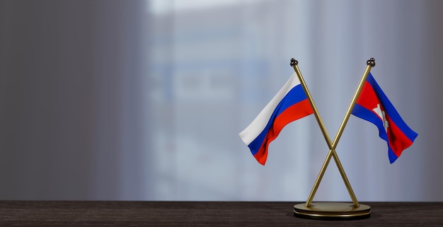 Drapeaux de la Russie et du Cambodge sur la table Négociation entre le Cambodge et la Russie sur un arrière-plan peu flou Travail 3D et image 3D