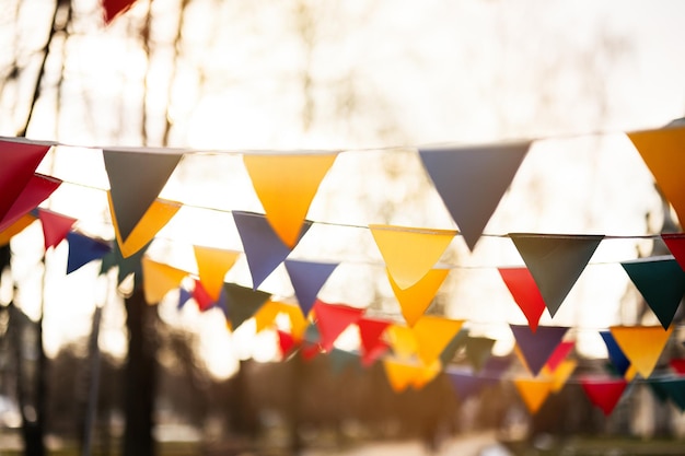 Drapeaux triangulaires colorés contre le ciel de coucher du soleil