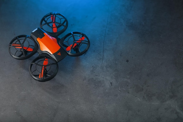 Un drone quadricoptère de reconnaissance avec un corps orange a
