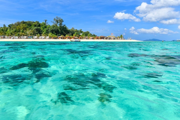 Du sable blanc devant les stations balnéaires et un bleu turquoise calme et limpide à Ko Lipe en Thaïlande