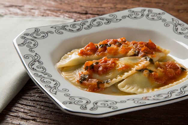 Dumplings à la viande avec tomate sur une assiette - Pierogi