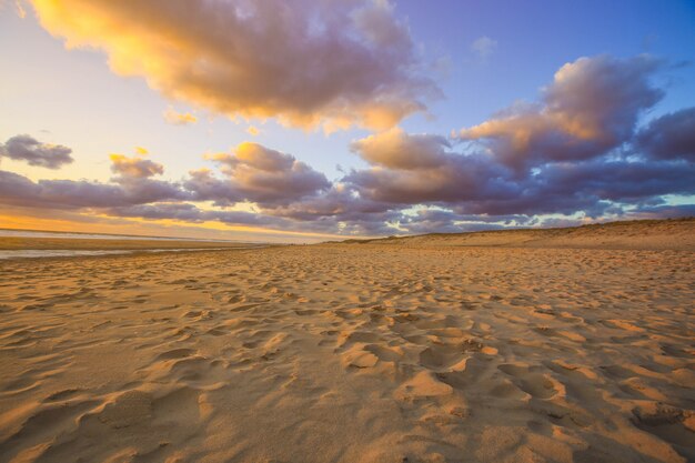 Dune de sable sur la plage au coucher du soleil pour le fond de la nature