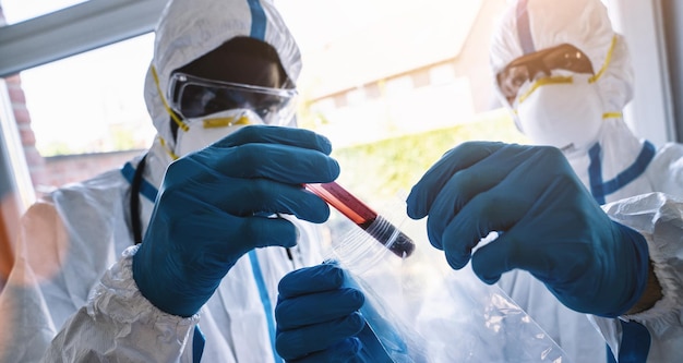 Un échantillon de sang de professionnels de la santé pour le test Covid19 est envoyé au laboratoire par des employés en vêtements de protection