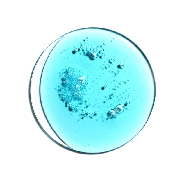 Photo Échantillon de texture de gel de sérum d'acide hyaluronique bleu sur fond blanc isolé macro cosmétiques