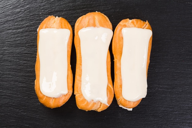 Eclairs à la chantilly sur fond noir